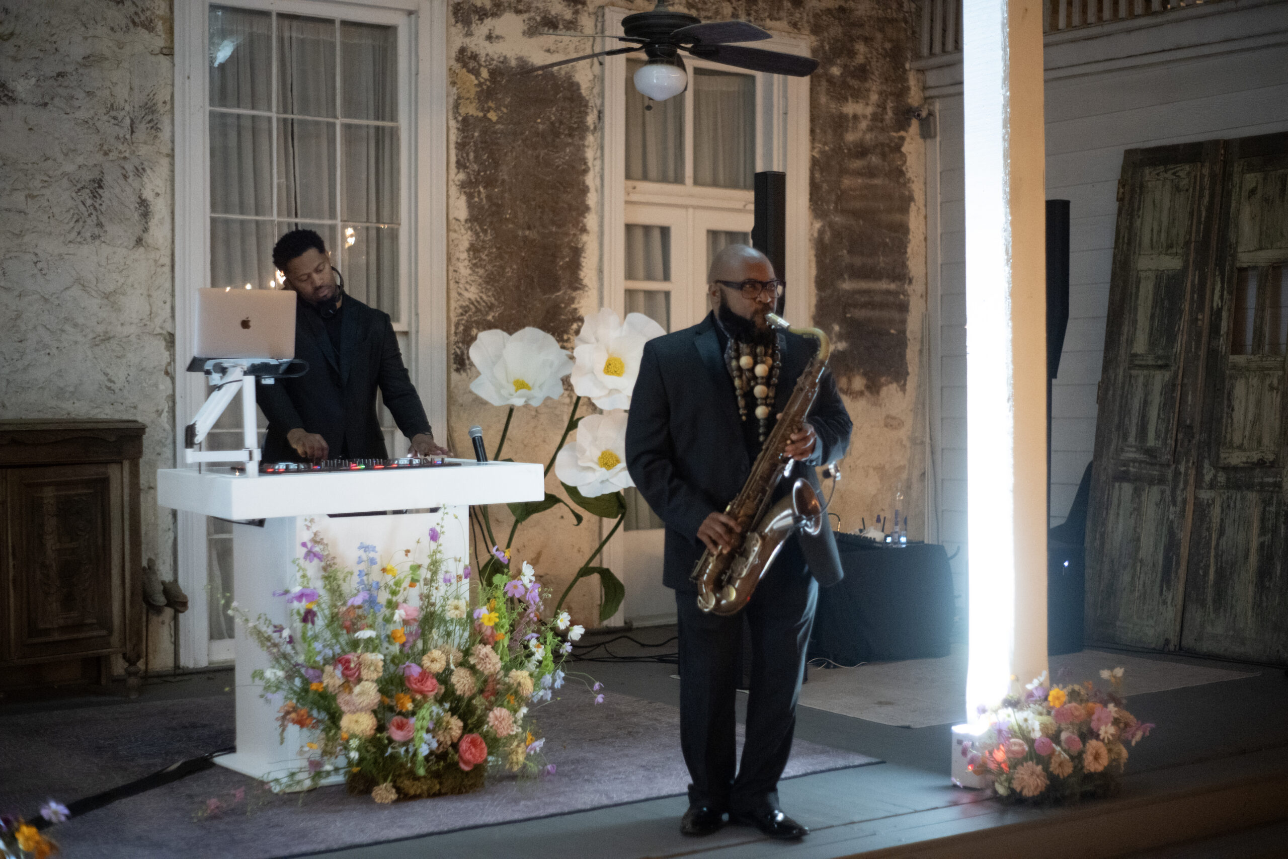 Saxophonist performing with a DJ at an elegant wedding reception